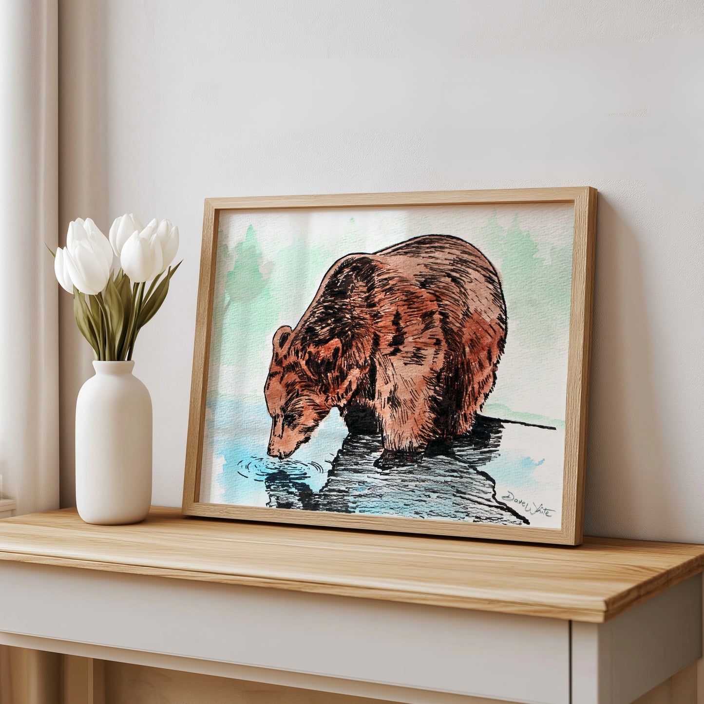 Framed artwork of a grizzly bear drinking water.
